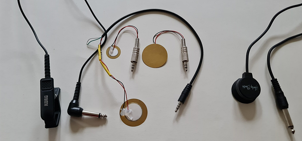 Different bought and self soldered contact mics